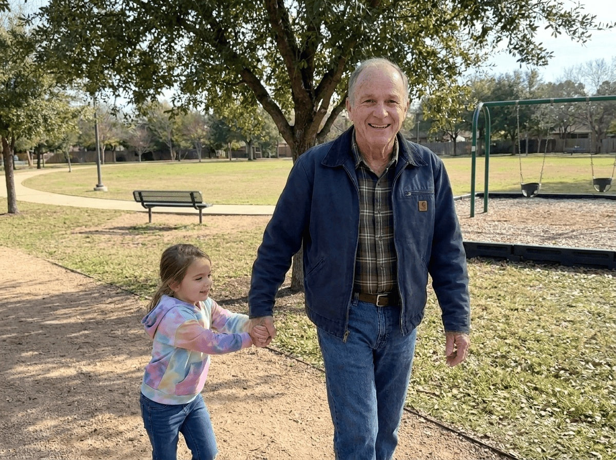 Grandfather walking in a park with his granddaughter